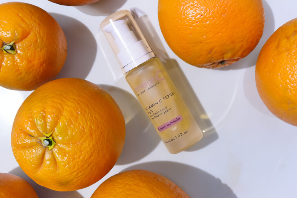 Sentence with Product Name: 20% vitamin C serum surrounded by fresh oranges, suggesting citrus-based skin nourishment.