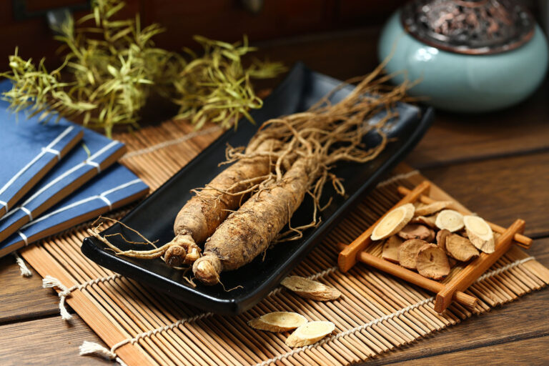 Ginseng in black plate on wooden table
