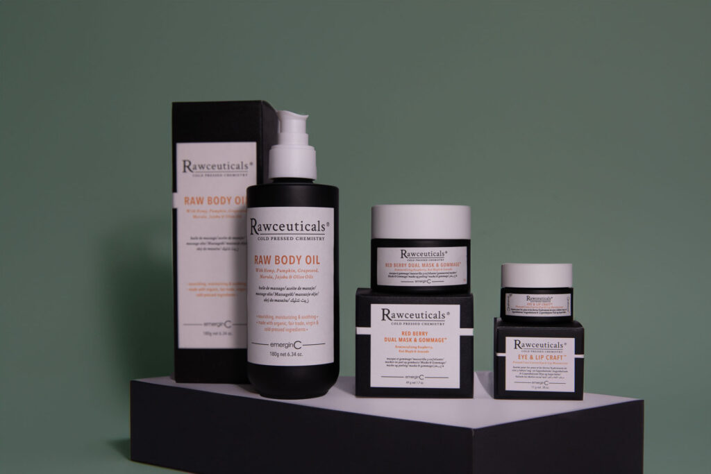 A collection of skincare products by rweceuticals, including bottles and jars on a black pedestal against a green background. the label shows 