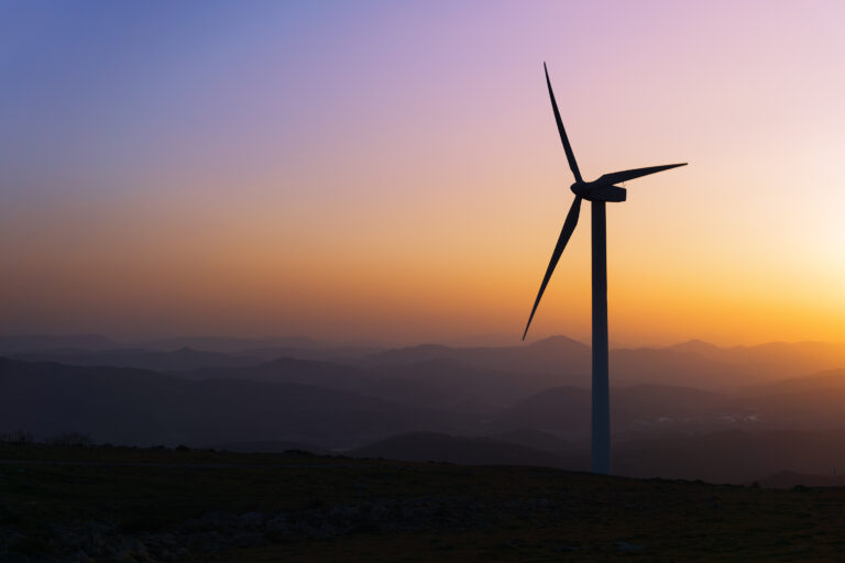 wind turbine silhouette on mountain at the sunset
