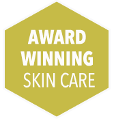 Hexagon-shaped label with the text award winning skin care in a yellow and white color scheme