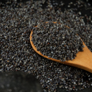 A close-up image of black poppy seeds in a wooden spoon against a dark background.