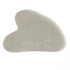 White heart-shaped Gua Sha with "emerginc" branding engraved on it.
