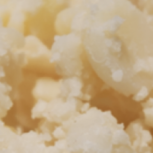 Close-up of creamy, crumbled feta cheese showing its texture.