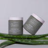 Elegantly presented at-home facial peel + clarifying kit flanked by fresh green aloe vera leaves against a neutral background, emphasizing natural ingredients and purity in cosmetic care.