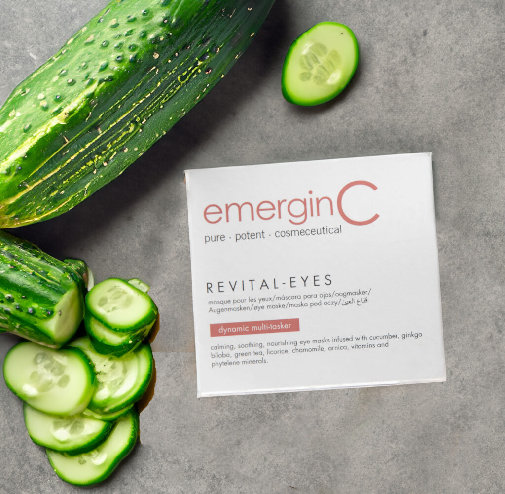 Fresh cucumber slices and revital-eyes on a minimalist grey background, hinting at natural ingredients and rejuvenation.