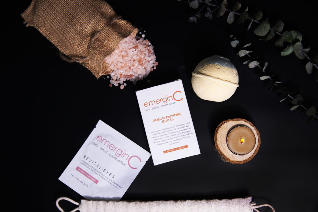 At-Home Luxury Spa Kit - Signature for a relaxing self-care routine, featuring bath salts, skincare products, a candle, and fresh eucalyptus on a dark background.