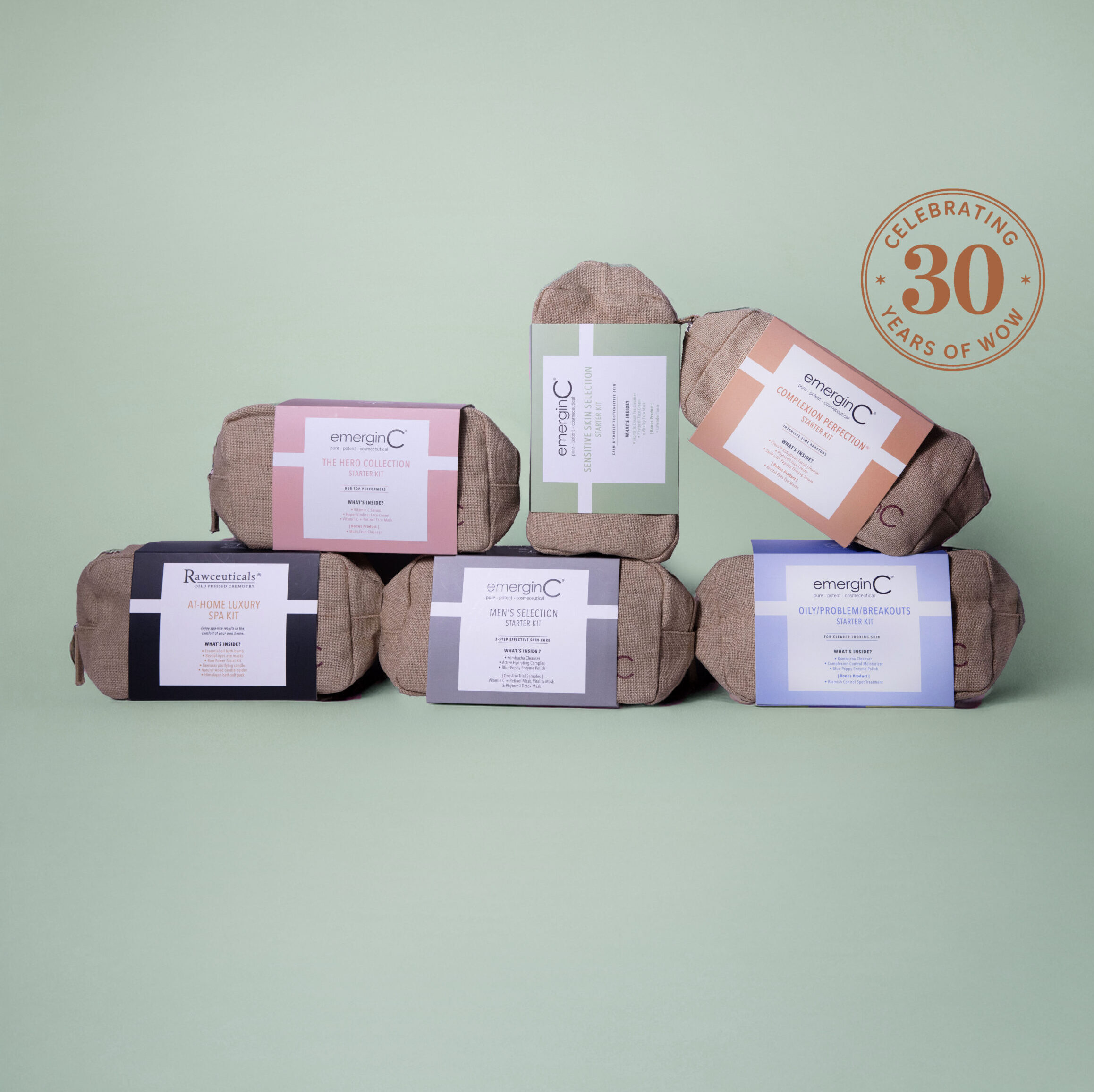 Six bundled toiletry kits with labeled tags are arranged in a pyramid shape on a light green background, showcasing professional luxury skin care essentials. A circular