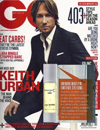 Cover of GQ Australia magazine featuring Keith Urban in a grey suit with a white shirt. The cover includes various headlines and an ad for Emergin-C Men’s P.M. Fighter, the award-winning skin care product, in the lower right corner.