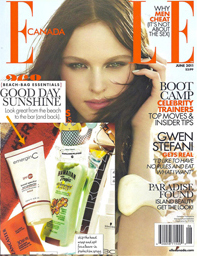 Cover of ELLE Canada magazine featuring a woman with long brown hair touching her face, with text about beach essentials, boot camp trainers, Gwen Stefani, and paradise makeup tips—plus award-winning skin care products pictured at the bottom.